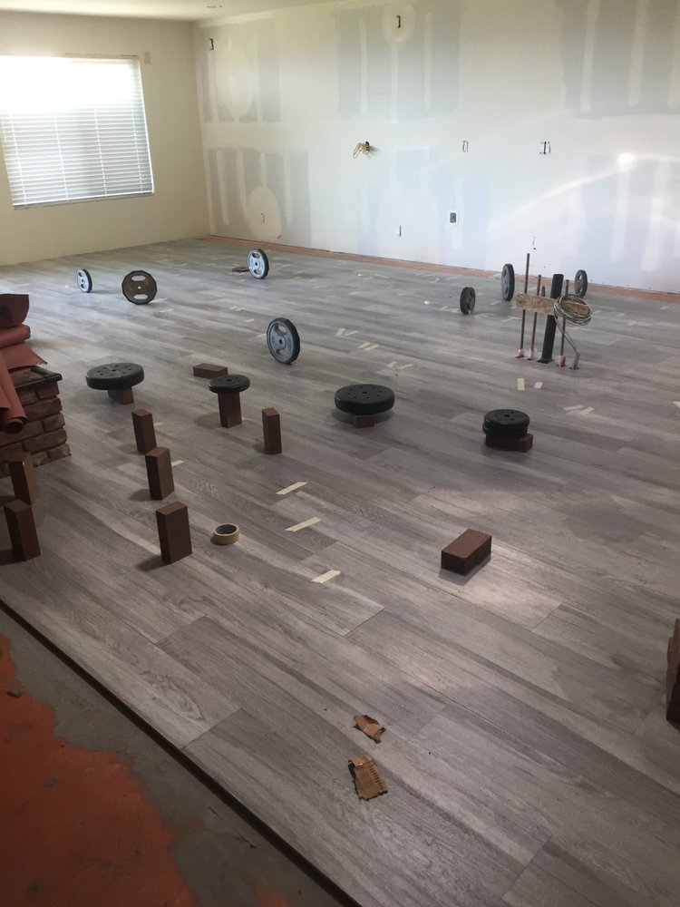 Luxury vinyl plank flooring being installed during a home remodel