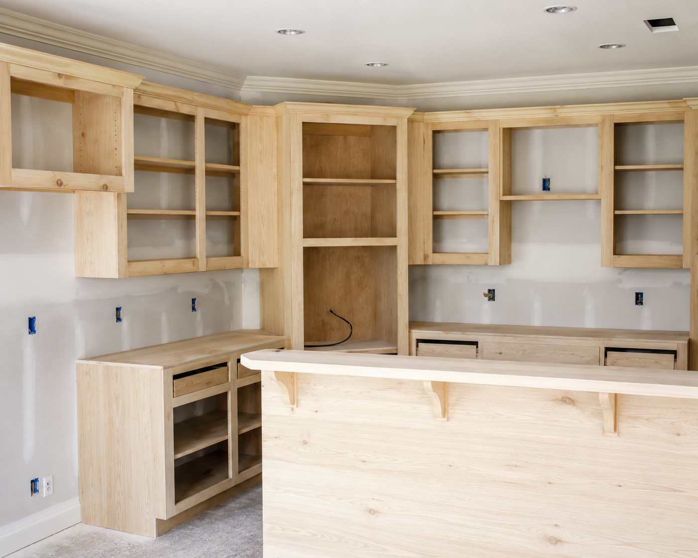 Unfinished kitchen cabinets and peninsula framing during a mobile home kitchen remodel