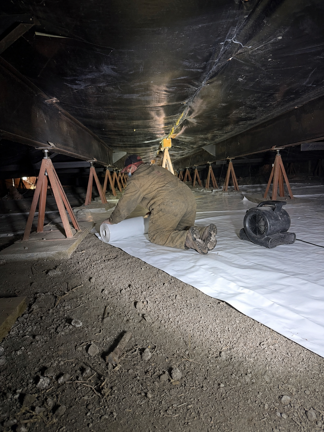 Cal Star crew installing a vapor barrier under a mobile home