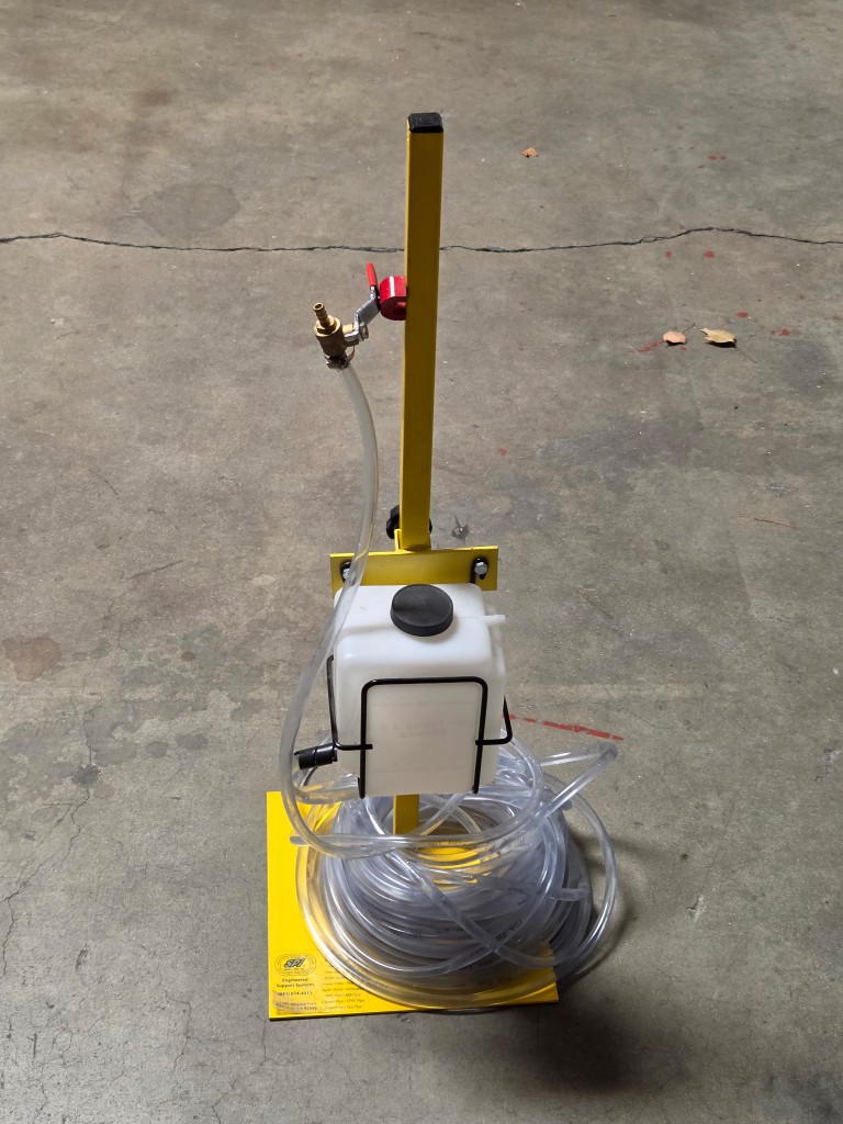 Cal Star hydrostatic water level tool with reservoir and hose used for mobile home leveling measurements