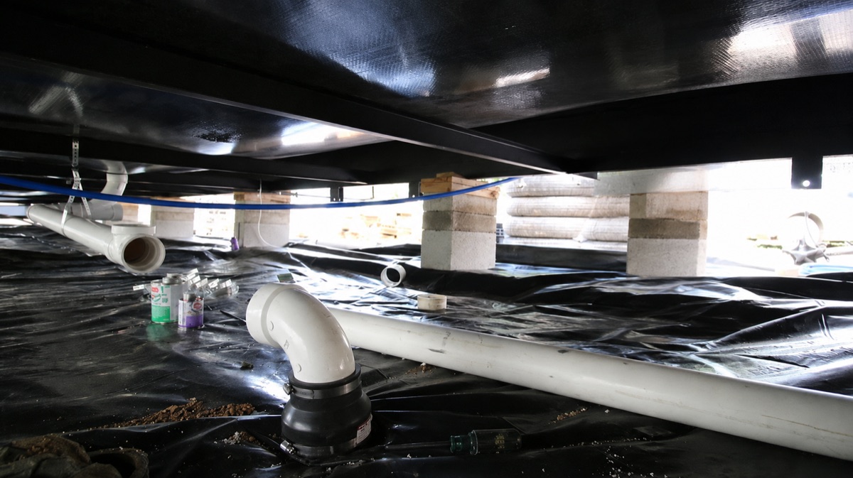 Cal Star plumber repairing mobile home plumbing under the floor
