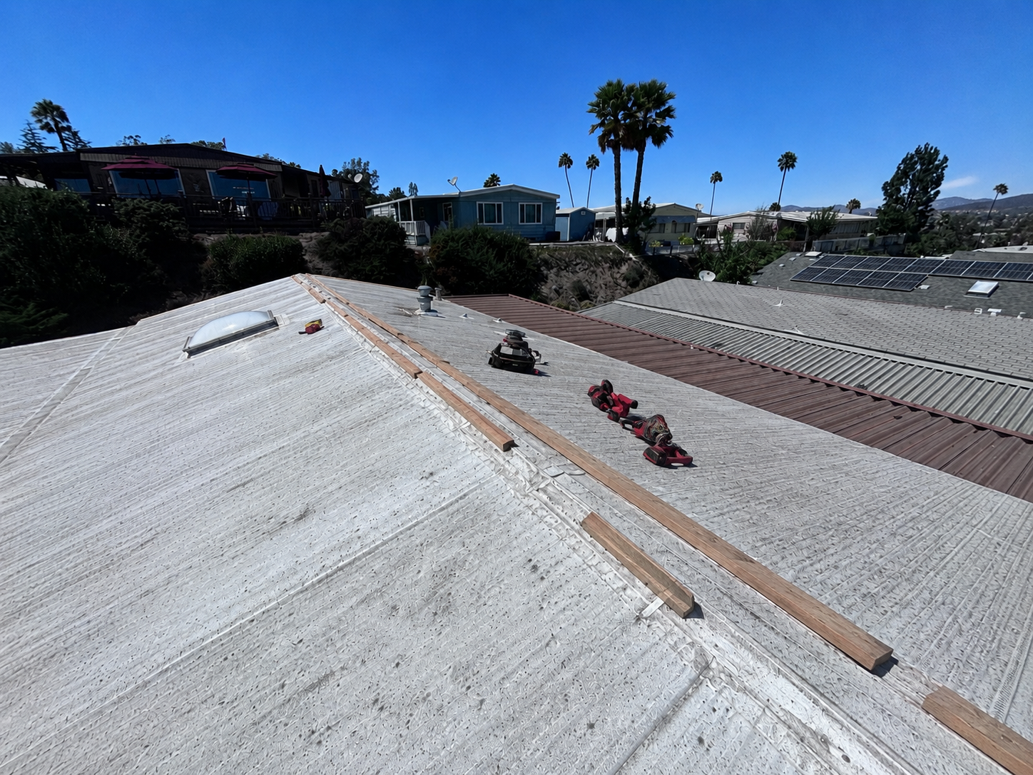 Worn corrugated metal mobile home roof before replacement