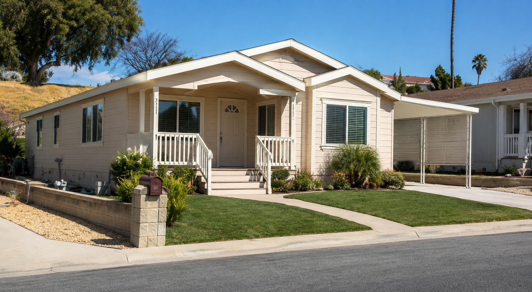 Completed mobile home with front carport, porch, and landscaping