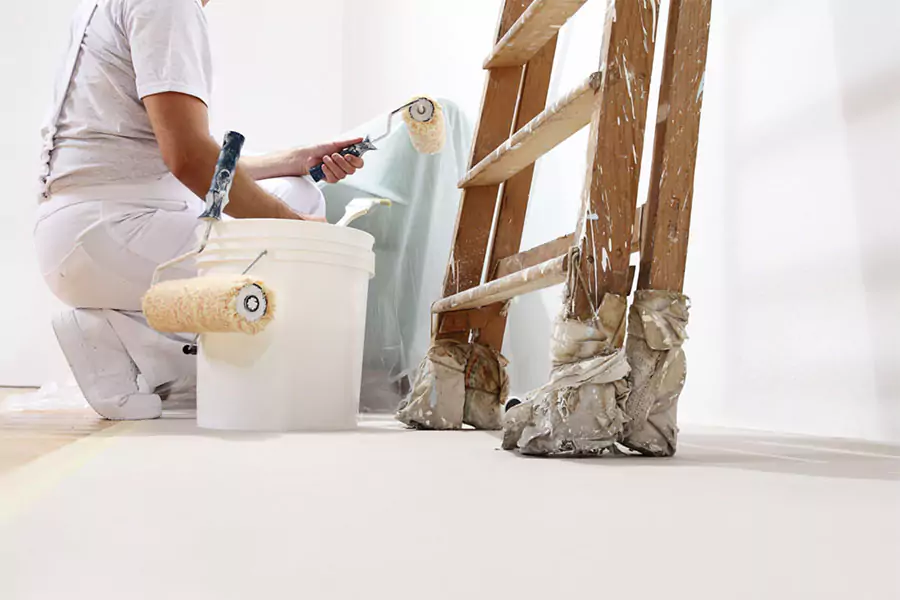 This image depicts a professional painter preparing to paint the interior of a mobile home, emphasizing the importance of hiring skilled mobile home painters in San Bernardino County.