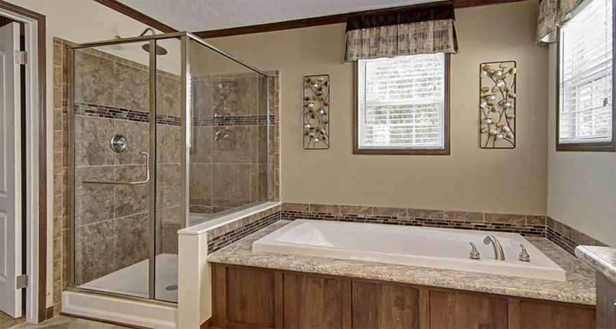 Modern mobile home bathroom with walk-in tile shower and built-in bathtub in Los Angeles County