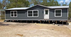 Mobile home elevated for releveling by contractor in Orange County to ensure structural stability and proper alignment