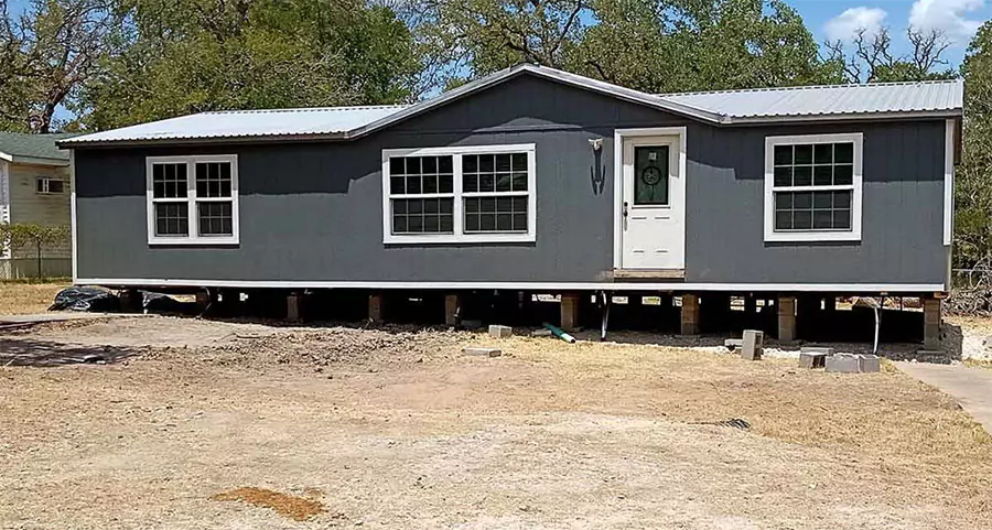 Mobile home elevated for releveling by contractor in Orange County to ensure structural stability and proper alignment