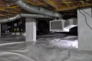 Encapsulated crawl space with vapor barrier, insulation, and ductwork in mobile home foundation to prevent soil erosion and moisture damage in Irvine, CA.