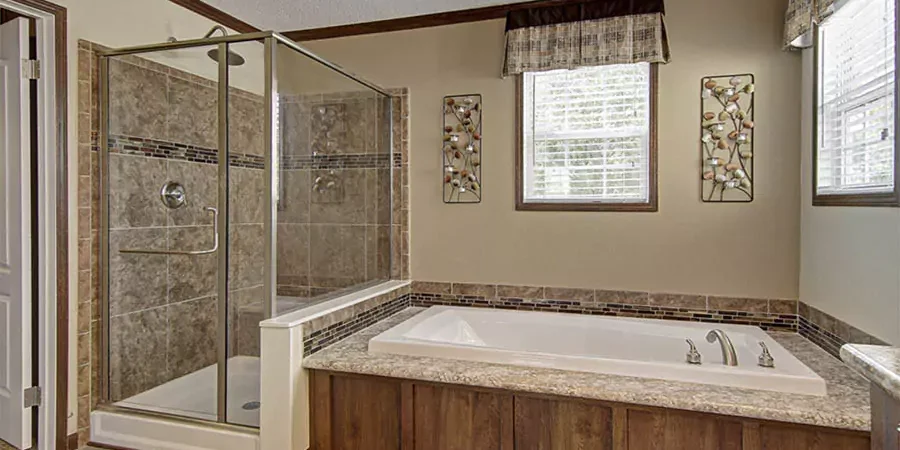 Modern mobile home bathroom with walk-in tile shower and built-in bathtub in Los Angeles County