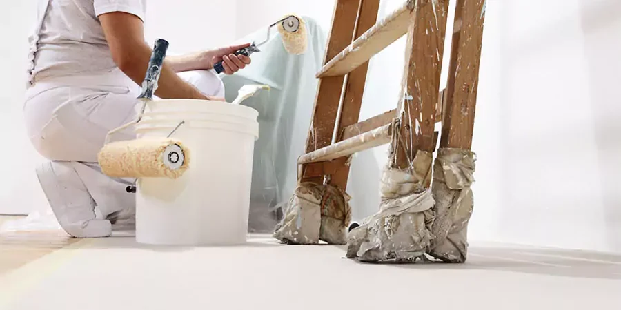 This image depicts a professional painter preparing to paint the interior of a mobile home, emphasizing the importance of hiring skilled mobile home painters in San Bernardino County.