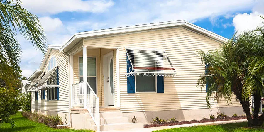 Mobile home with green lawn and blue sky